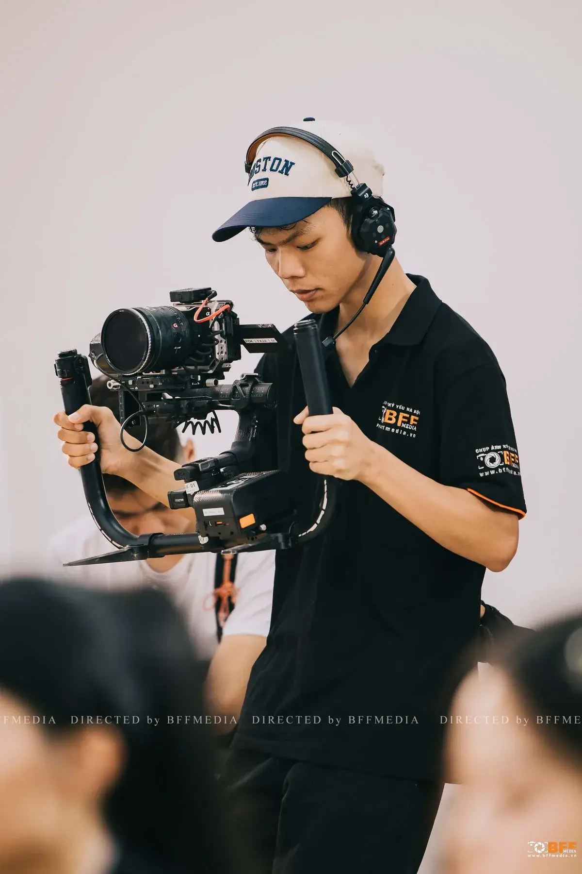 Quay phim BFFMEDIA cầm máy quay gắn gimbal khi quay video kỷ yếu cho lớp